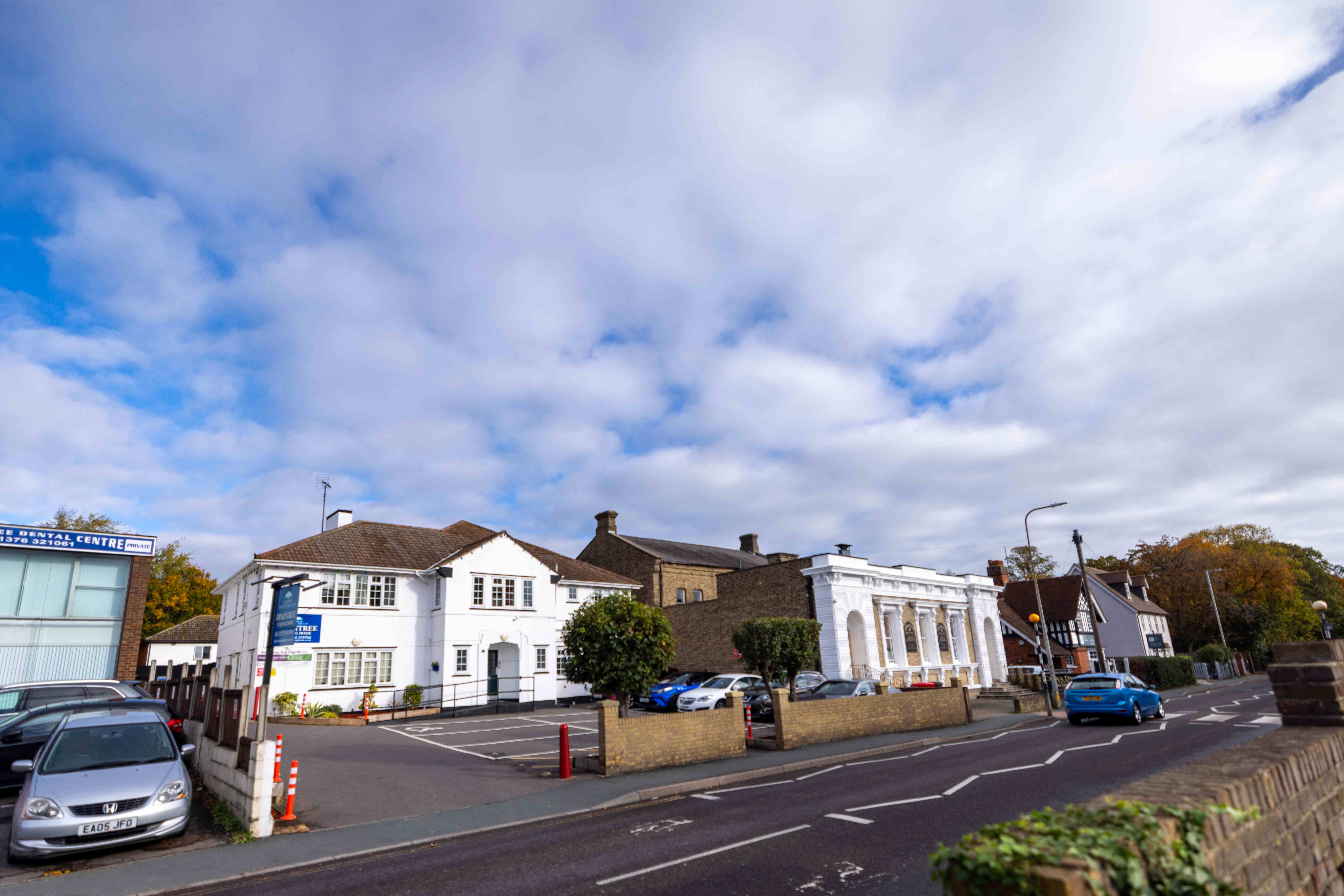 Wide street view of the building